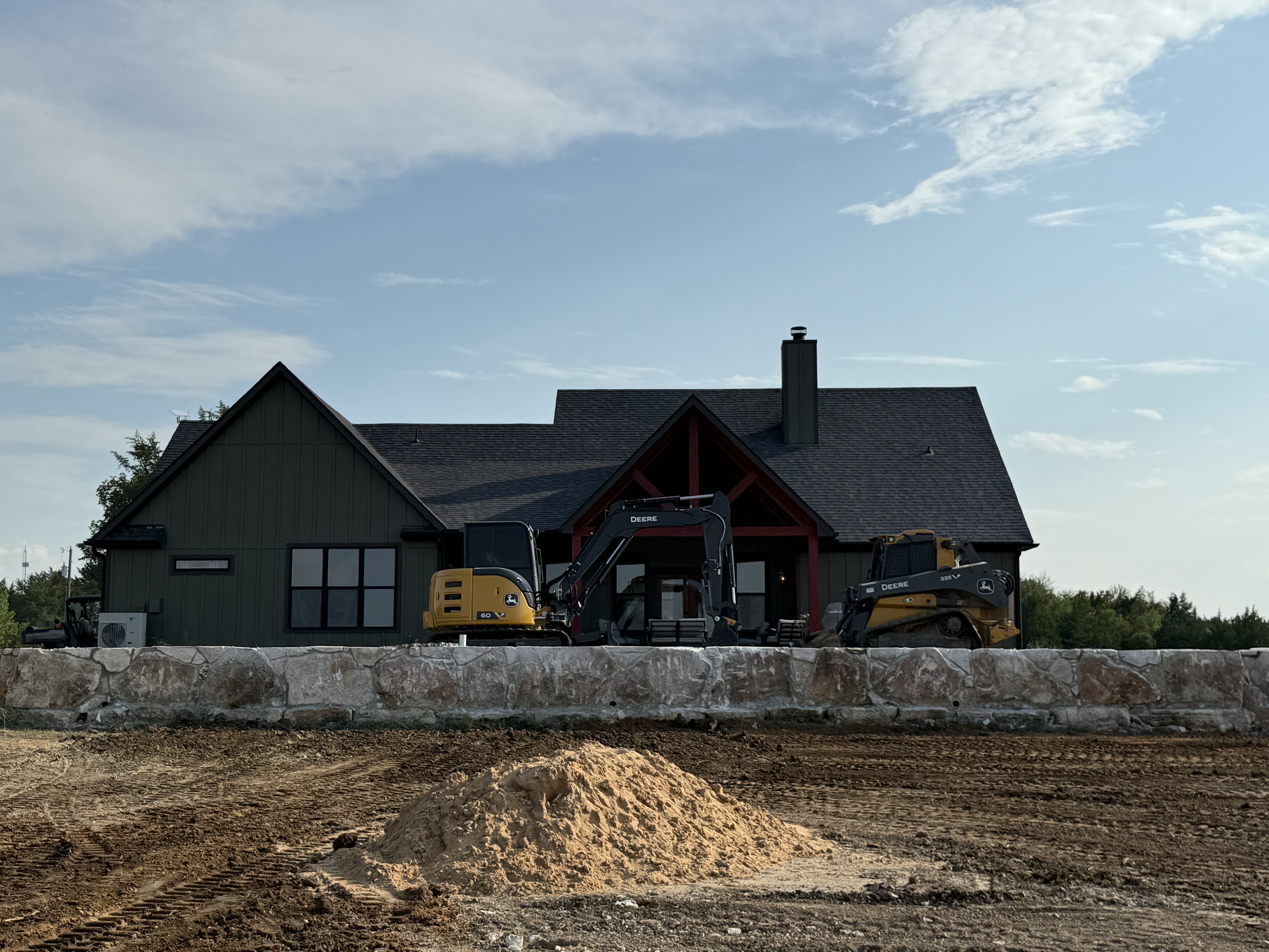 Large block retaining wall installed on a sloped property for erosion control and grade support